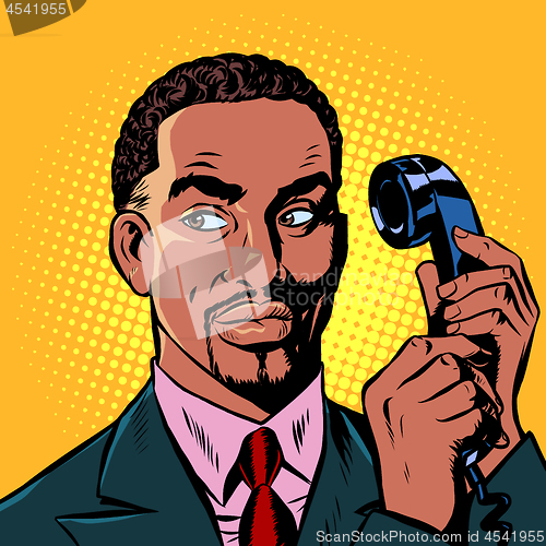 Image of serious african man talking on a retro phone