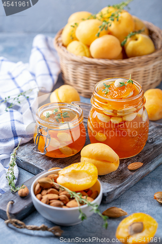 Image of Homemade apricot jam with thyme and sweet almonds.