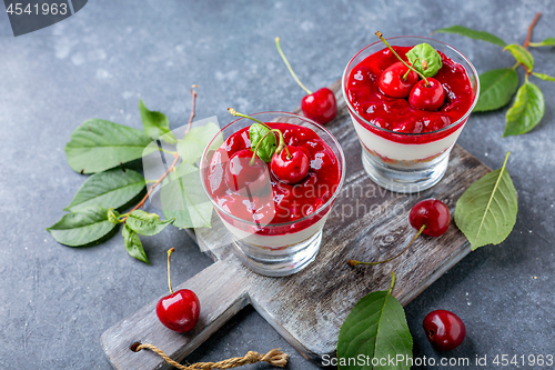 Image of Sweet cherry cheesecake in glasses.