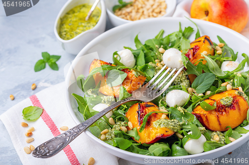 Image of Salad with grilled nectarines, arugula and pesto.