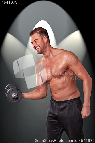 Image of Shirtless man with dumbbell