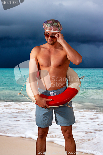 Image of portrait of shirtless man standing at beach