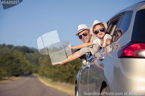 Image of Happy father and son sitting in the car at the day time.