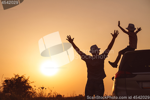 Image of Father and son playing in the park at the sunset time.