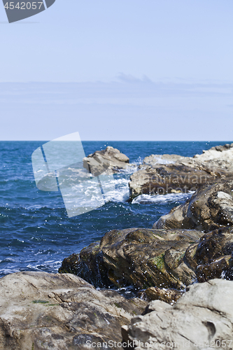 Image of Blue sea water, stones and rocks on Adriatic sea coast.