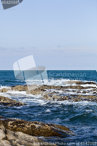 Image of Blue sea water, stones and rocks on Adriatic sea coast.