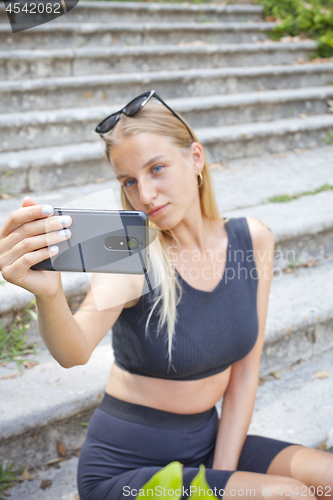 Image of Attractive young woman taking selfie on the ancient town.