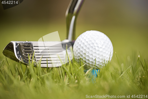 Image of Golf ball on tee in front of driver