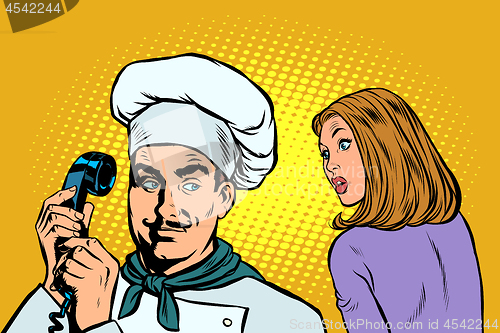 Image of chef on the phone, a woman client listens