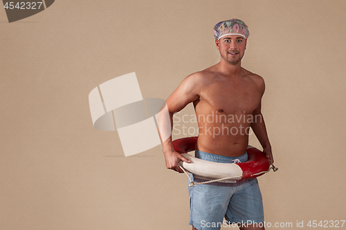 Image of portrait of shirtless man standing against 