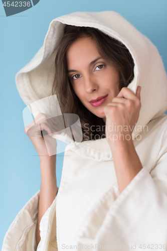 Image of woman in a white coat with hood isolated on blue background