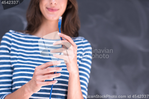 Image of woman holding a internet cable in front of chalk drawing board