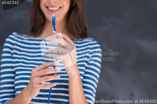 Image of woman holding a internet cable in front of chalk drawing board
