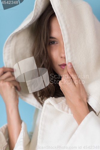 Image of woman in a white coat with hood isolated on blue background