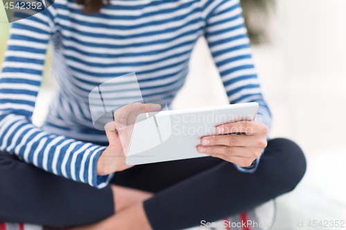 Image of young women using tablet computer on the floor