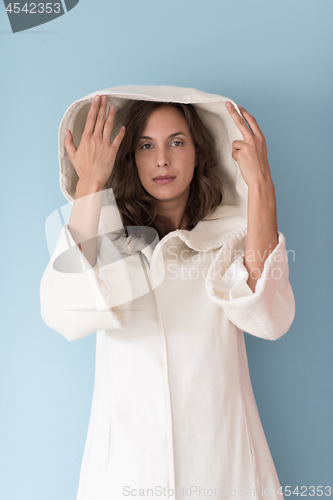 Image of woman in a white coat with hood isolated on blue background