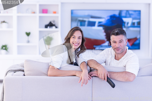 Image of Young couple on the sofa watching television