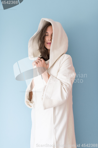 Image of woman in a white coat with hood isolated on blue background