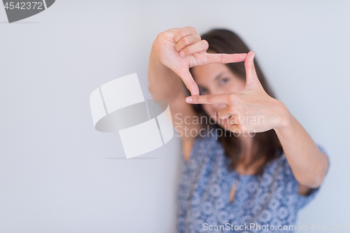 Image of woman showing framing hand gesture