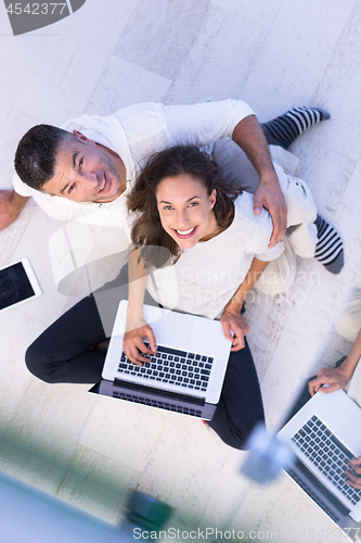 Image of couple using tablet and laptop computers top view
