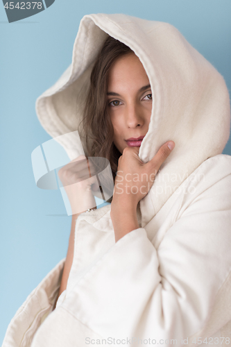 Image of woman in a white coat with hood isolated on blue background