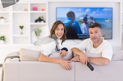 Image of Young couple on the sofa watching television