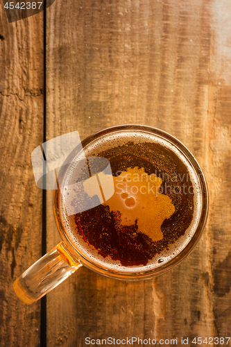 Image of Belgian beer concept, Belgium silhouette on foam in beer glass on wooden table.