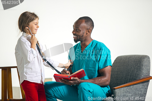 Image of healthcare and medical concept - doctor and girl with stethoscope in hospital