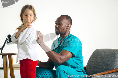 Image of healthcare and medical concept - doctor with stethoscope listening to child chest in hospital