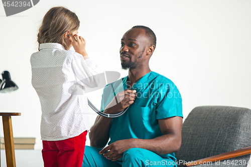 Image of healthcare and medical concept - doctor with stethoscope listening to child chest in hospital