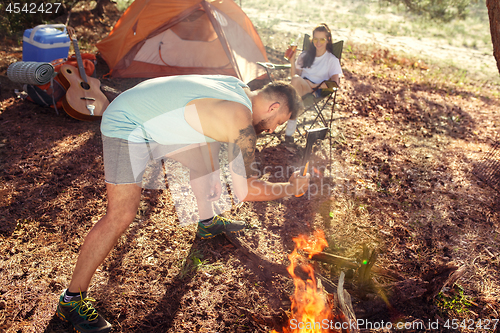 Image of Party, camping of men and women group at forest. They relaxing