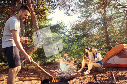 Image of Party, camping of men and women group at forest. They relaxing