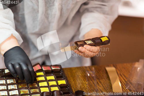 Image of worker packing candies at confectionery shop