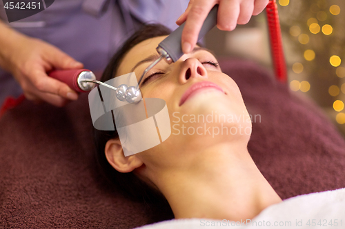 Image of woman having hydradermie facial treatment in spa