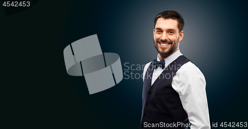 Image of man in shirt and bowtie over black background