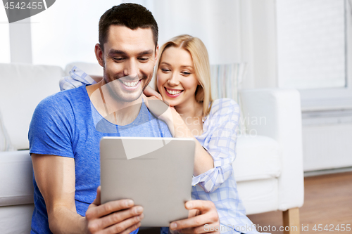 Image of happy couple with computer at home