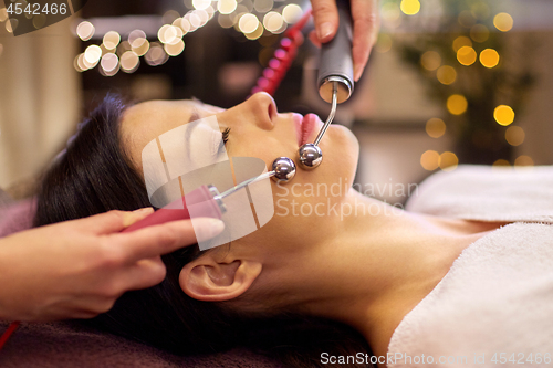 Image of woman having hydradermie facial treatment in spa