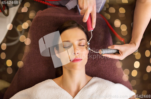 Image of woman having hydradermie facial treatment in spa