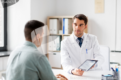 Image of doctor with tablet computer and patient at clinic