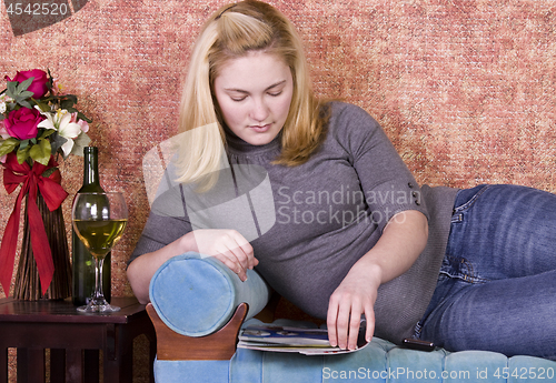 Image of Beautiful Woman Reading a Magazine