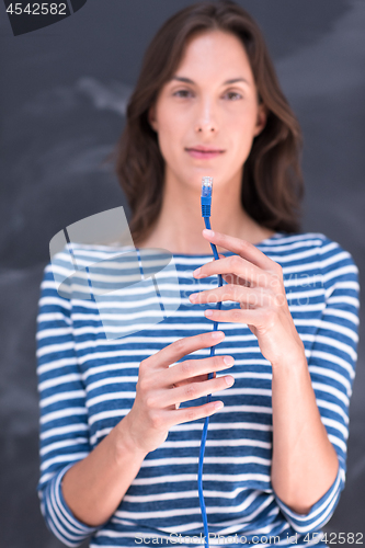 Image of woman holding a internet cable in front of chalk drawing board