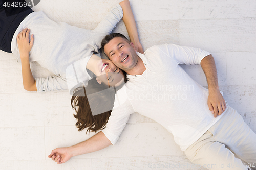 Image of handsome couple lying on floor