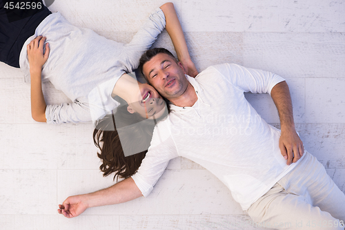 Image of handsome couple lying on floor