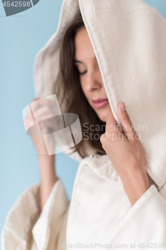 Image of woman in a white coat with hood isolated on blue background