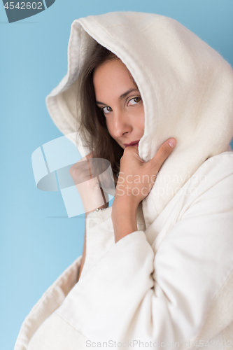 Image of woman in a white coat with hood isolated on blue background