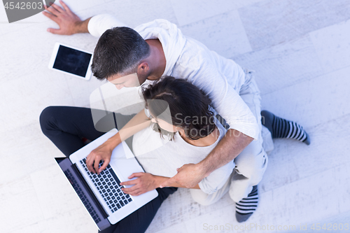 Image of couple using tablet and laptop computers top view
