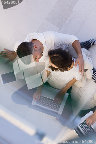 Image of couple using tablet and laptop computers top view