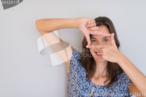 Image of woman showing framing hand gesture