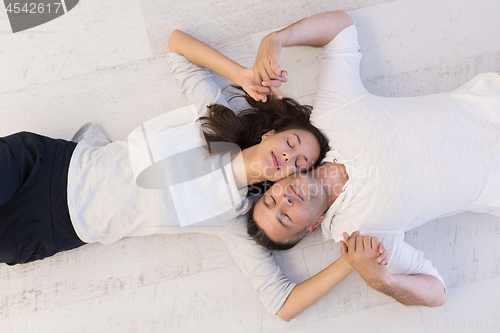 Image of handsome couple lying on floor