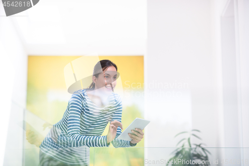 Image of young woman at home websurfing